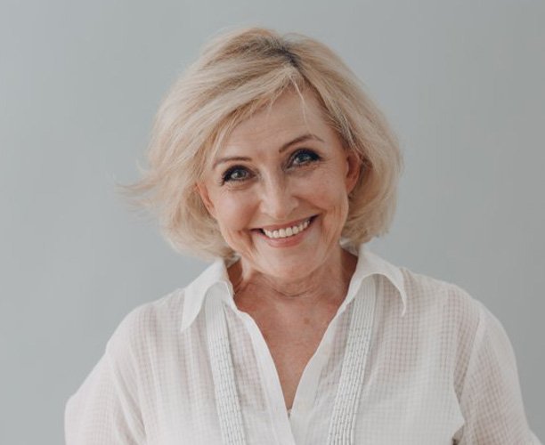 Lady smiles with dentures