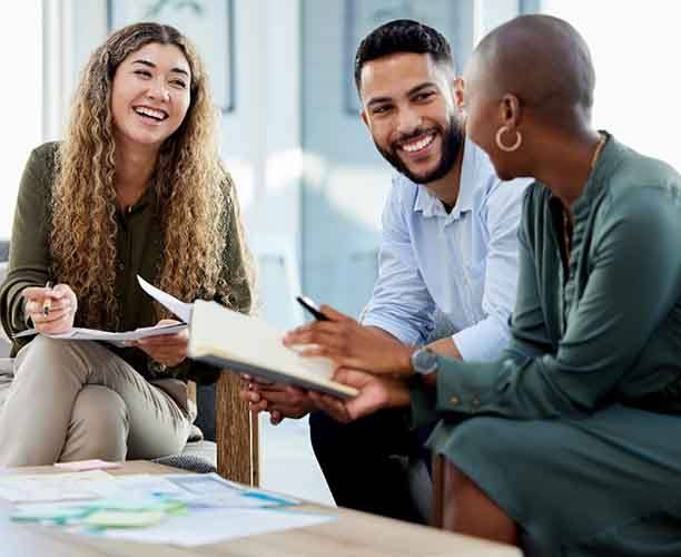 Group of co-workers smiling together at work