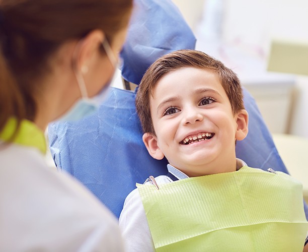 Young boy smiling during first children's dentistry appointment
