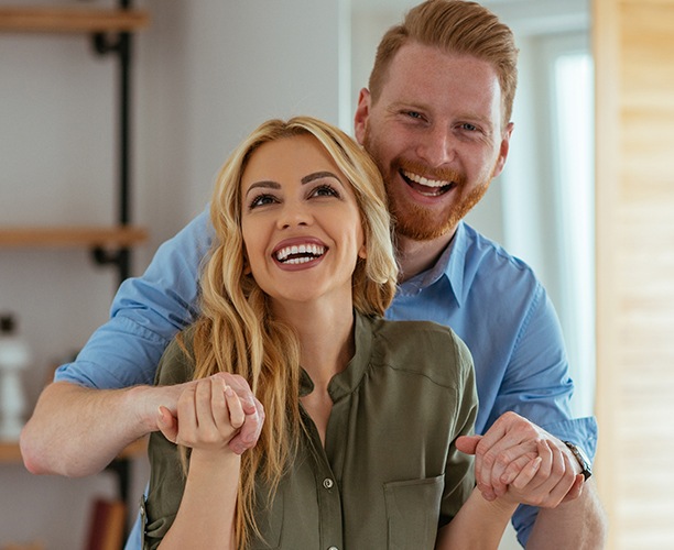 Man and woman smiling together after dental visit