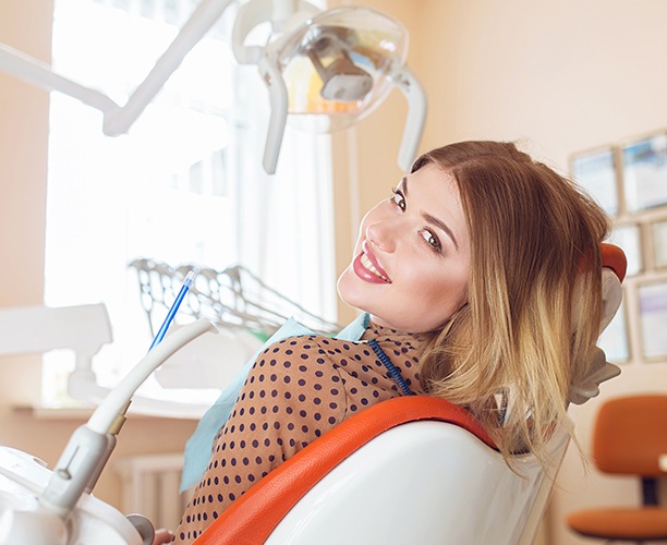 Woman in dental chair smiling