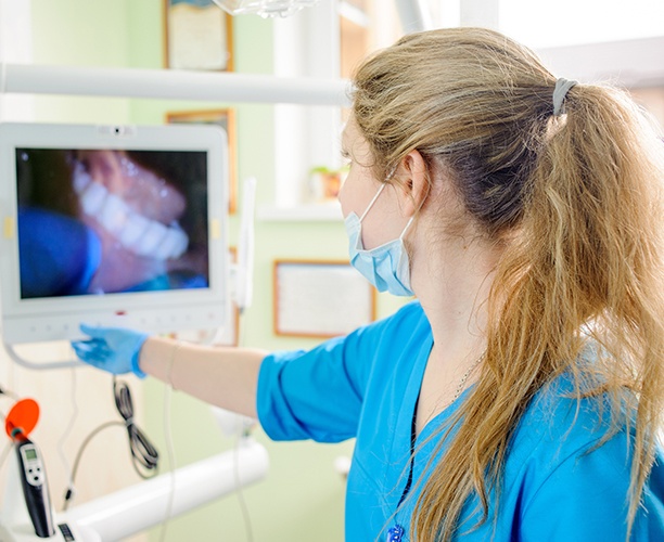 Dentist looking at images from intraoral camera