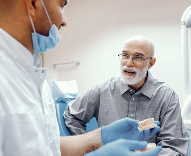 senior man smiling after getting dentures in Las Cruces, NM