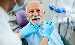 Man with white hair about to undergo dental exam