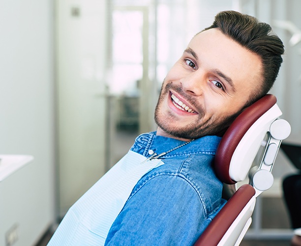 Man in dental chair for preventive dentistry to prevent dental emergencies