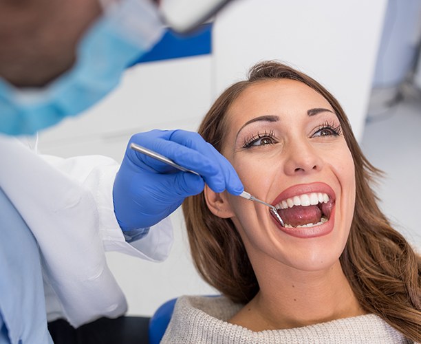 Patient receiving preventive dentistry checkup and teeth cleaning