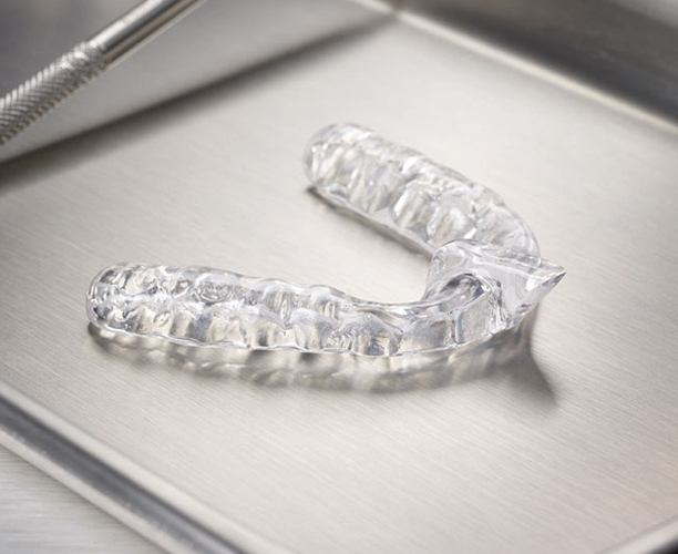 Clear nightguard for T M J and bruxism therapy on metal tray