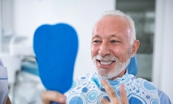 man admiring his new teeth