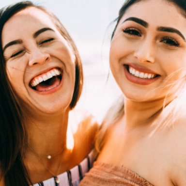 Two women laughing in the sunlight