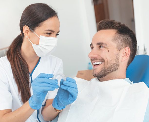 Invisalign dentist in Las Cruces showing a patient how Invisalign works 