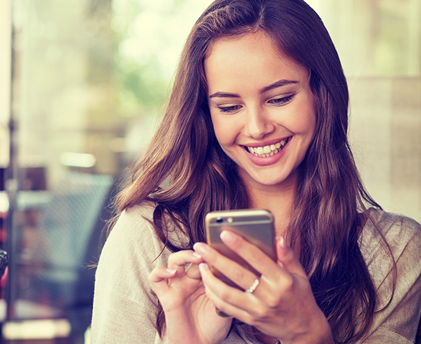 Woman scheduling an appointment using her cell phone