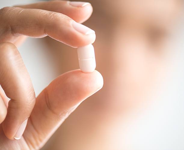 Hand holding an oral conscious sedation dentistry pill