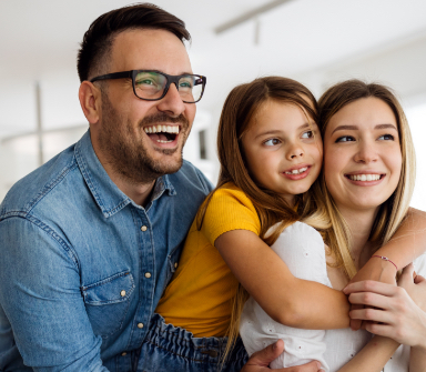 Mother father and child with healthy smiles after family preventive dentistry visit