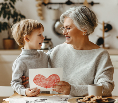 Grandmother smiling at grandson after dental implant tooth replacement