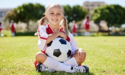 Little girl smiles on soccer field
