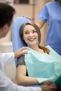 A patient discusses dental implants with her doctor.