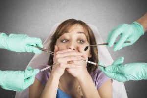 Woman covering her mouth at the dentist