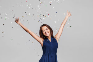 Woman with healthy smile dancing in glitter