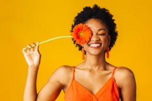 a woman with a beautiful smile holding spring flowers