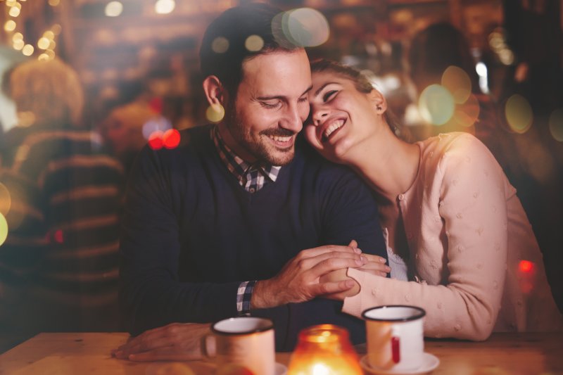 A couple with good dental health smiling at each other