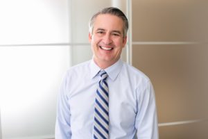 Smiling middle-aged man in business attire 