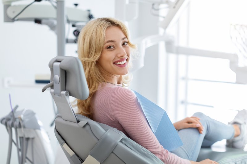 A smiling young woman sitting in a dentist’s chair