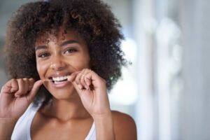 Woman flossing.